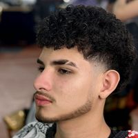 Curly top with a clean taper fade