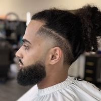 Man bun with a full beard and line-up