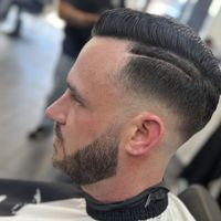 Hard part pompadour with a skin fade